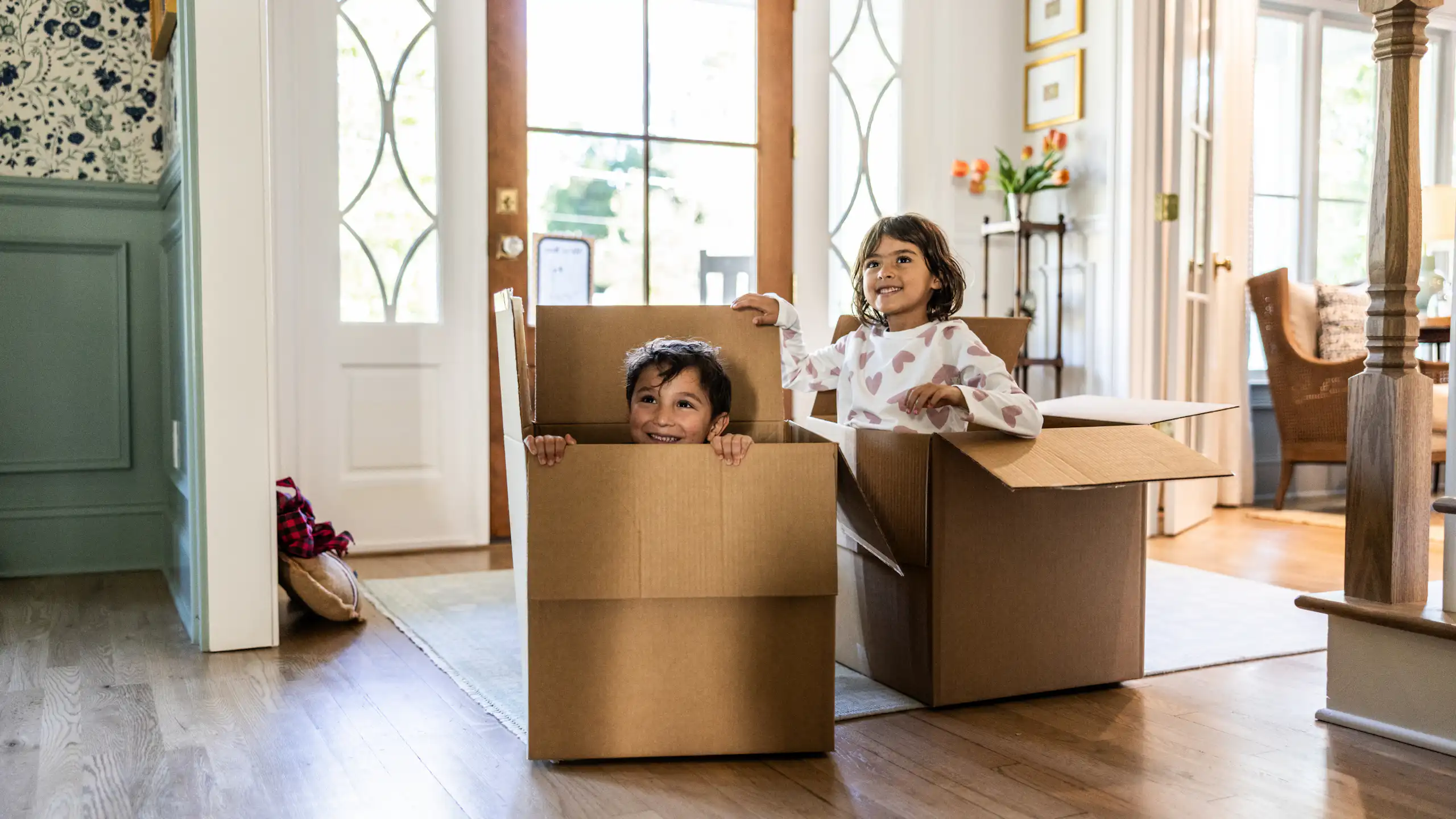 Children playing in empty boxes