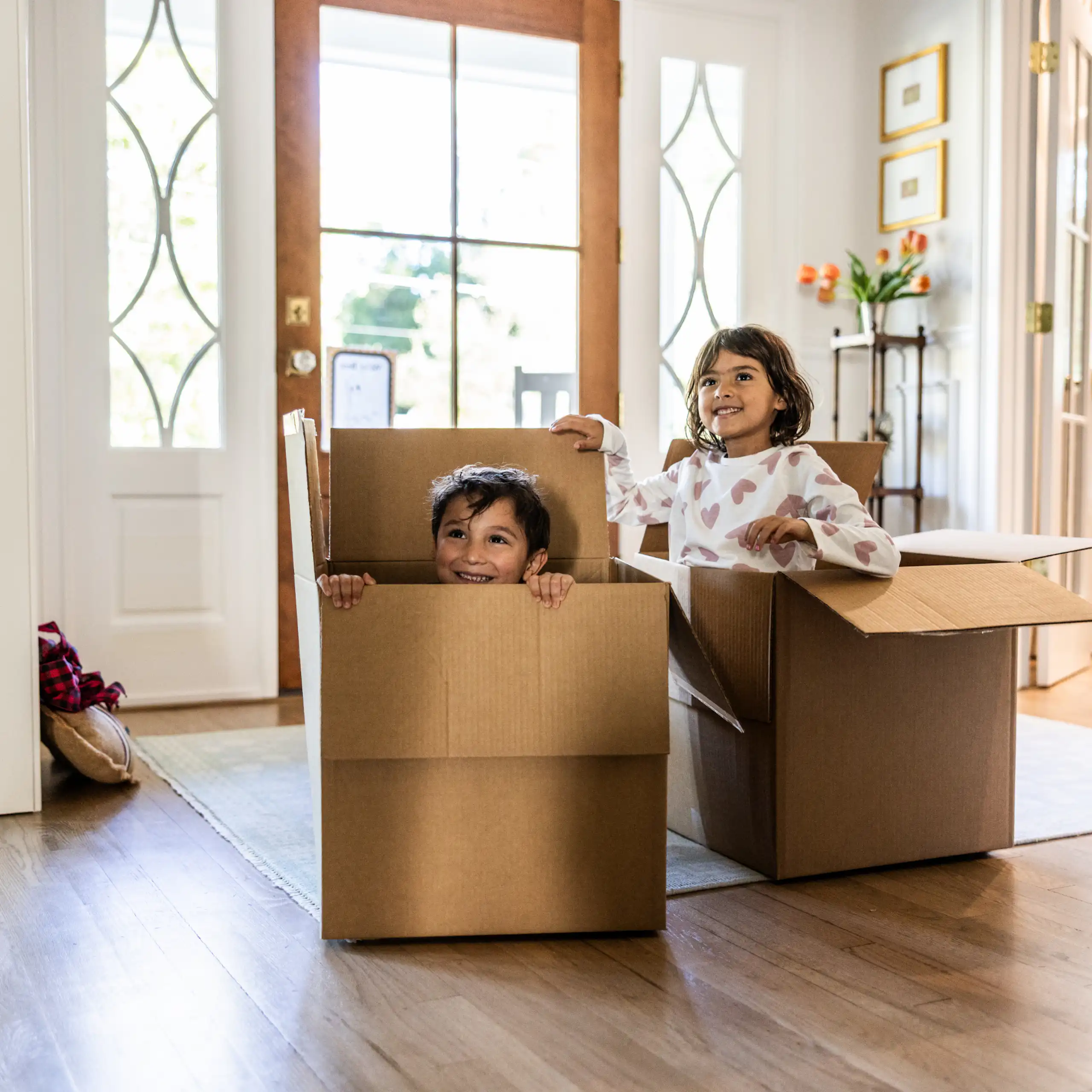 Children playing in empty boxes