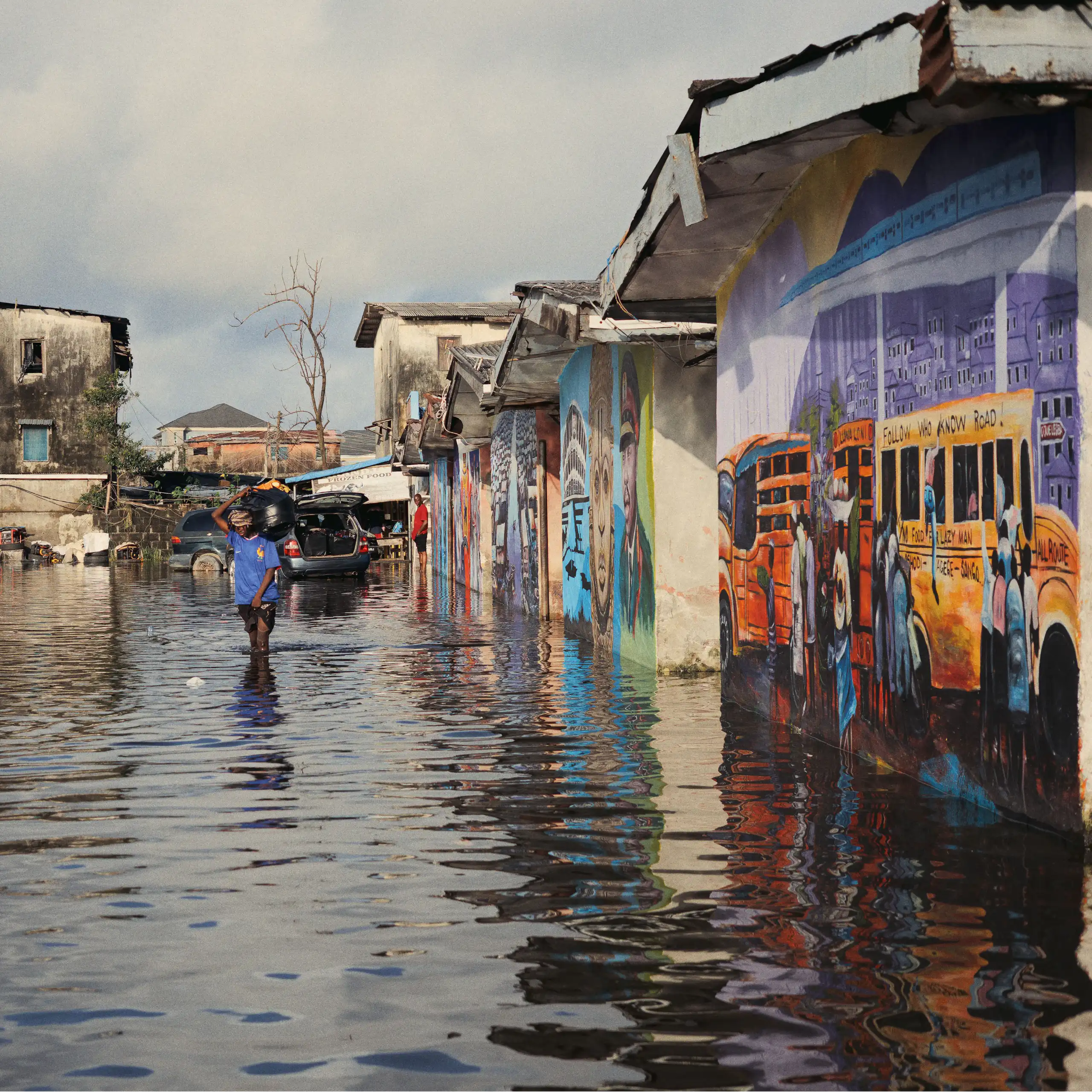 People wading down a flooded street
