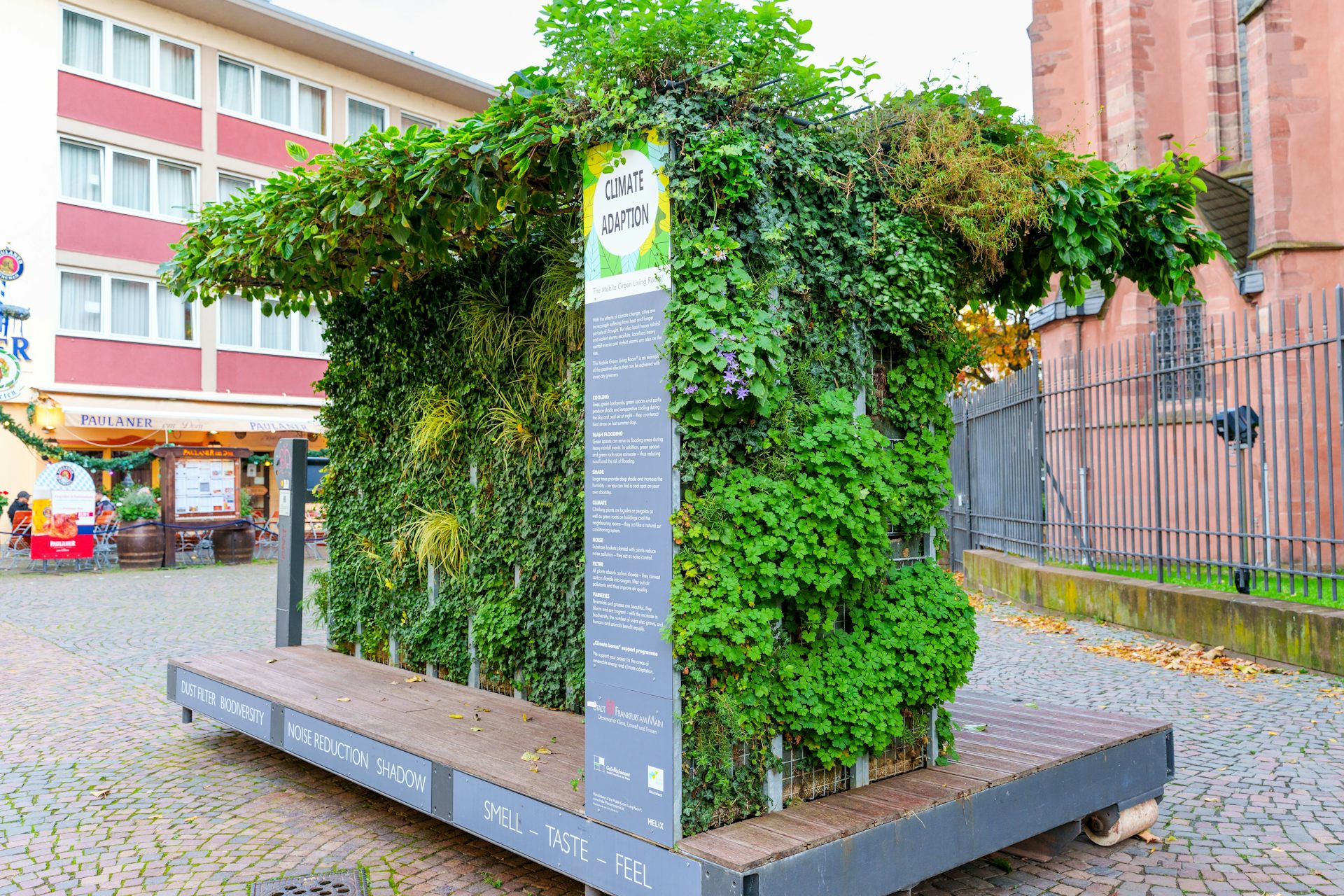 Pan de mur végétalisé en exposition sur une place publique poue en expliquer les avantages.
