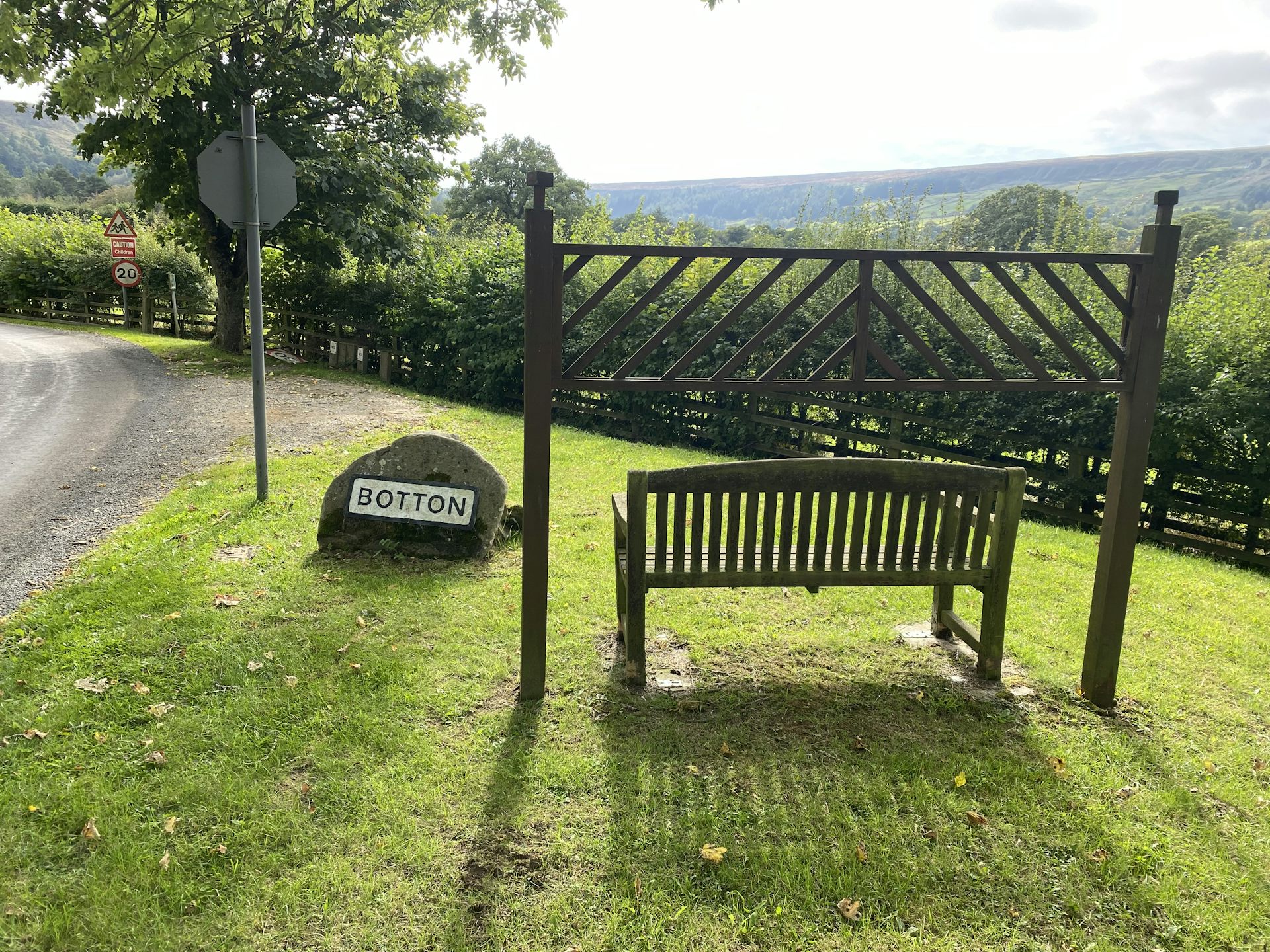 Bench at entrance to picturesque village.