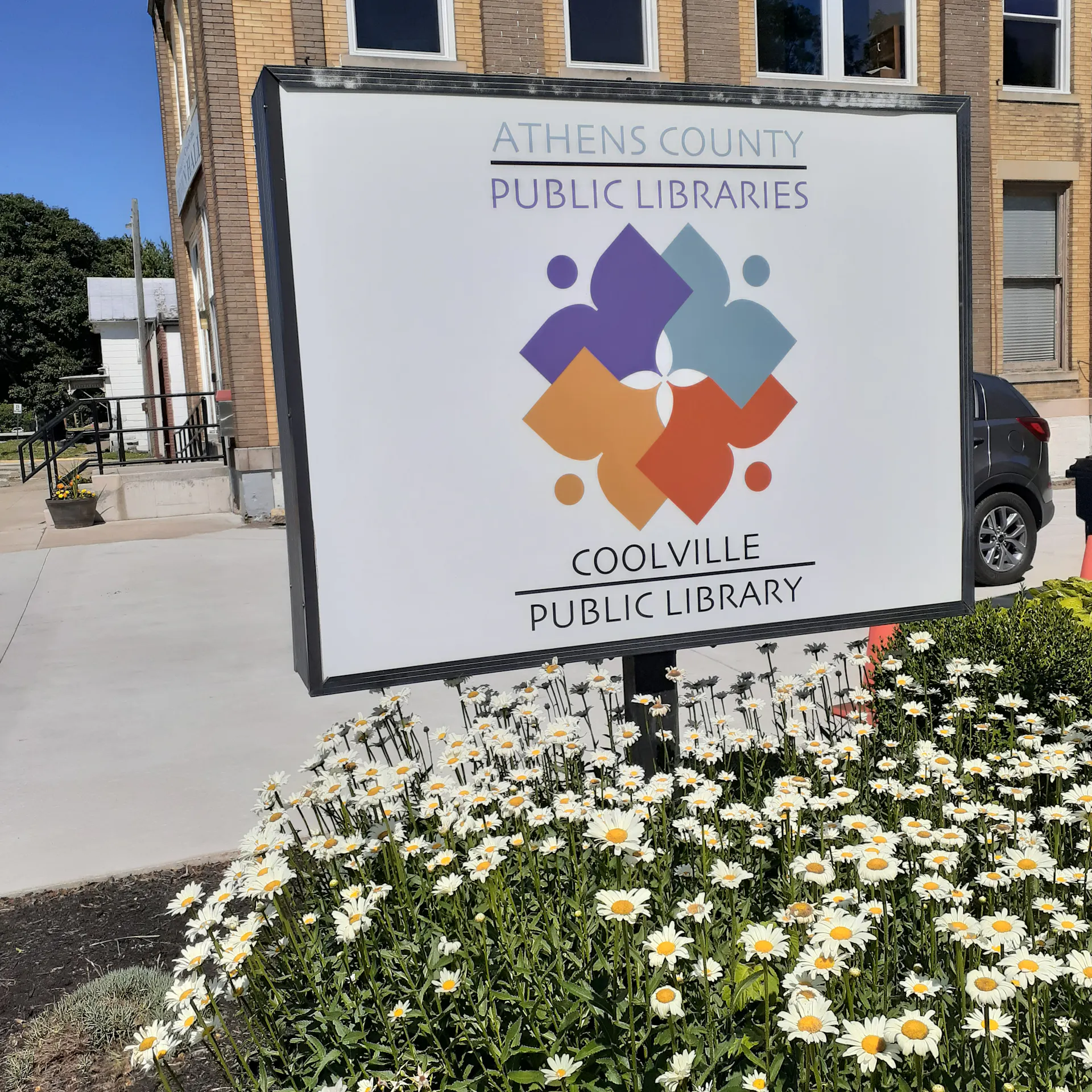 A library sign reading 'Coolville Public Library'