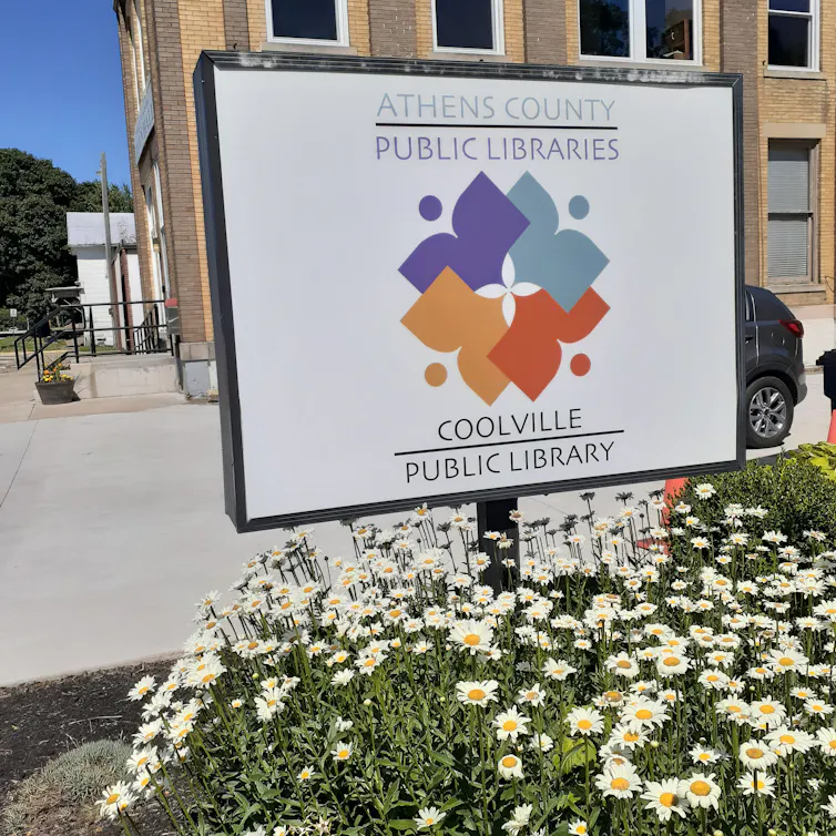 A library sign reading 'Coolville Public Library'