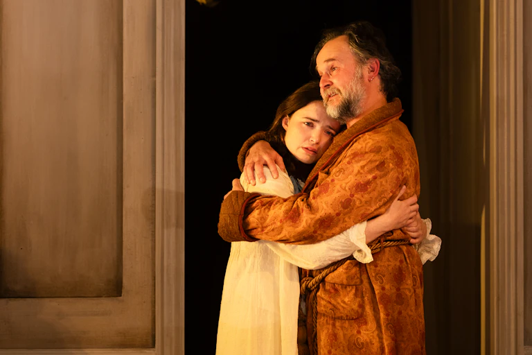 Production image: Uncle Vanya hugs his niece.