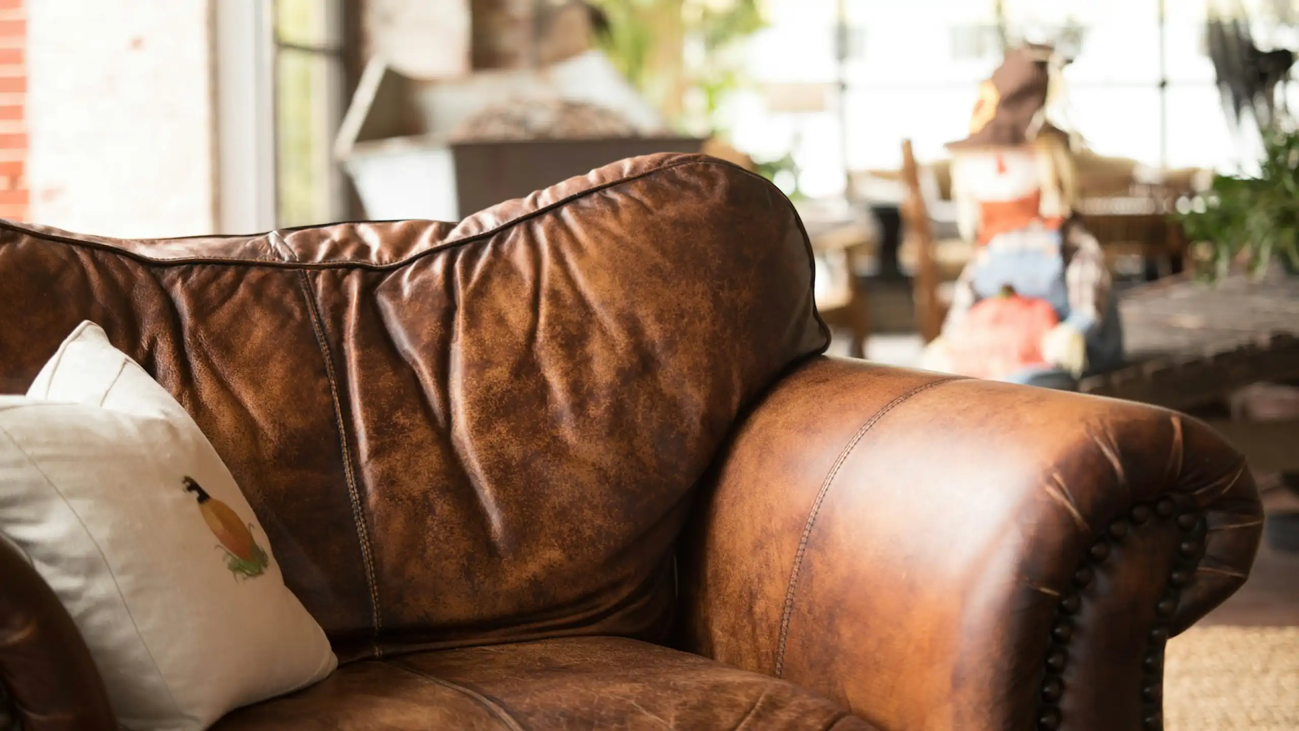 Old brown leather sofa in warehouse or apartment