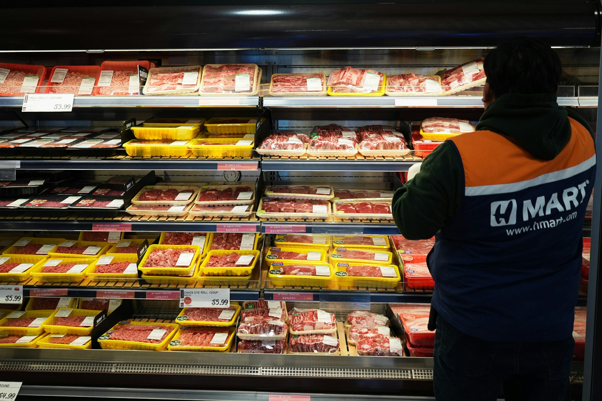An employee stands in front of the meat department in a grocery store in Schaumburg, Ill.