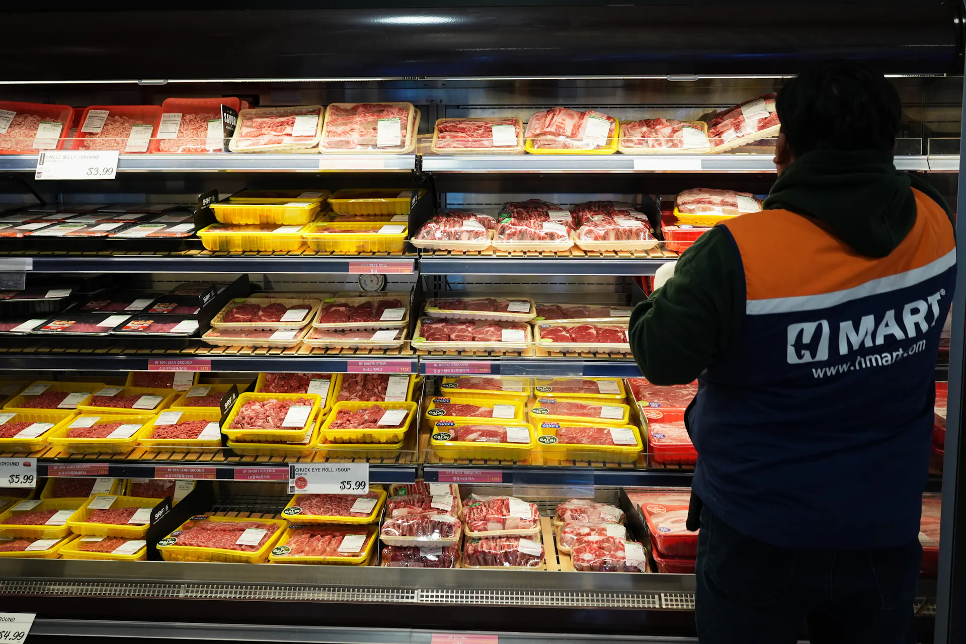 An employee stands in front of the meat department in a grocery store in Schaumburg, Ill.