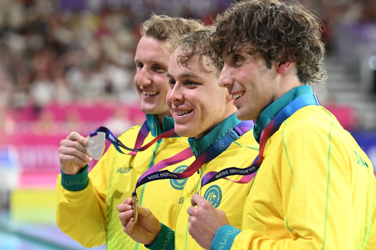 Australians Elijah Winnington, Sam Short, and Benjamin Goedemans celebrate their medals from the 400m freestyle final at the Glasgow Commonwealth Games.