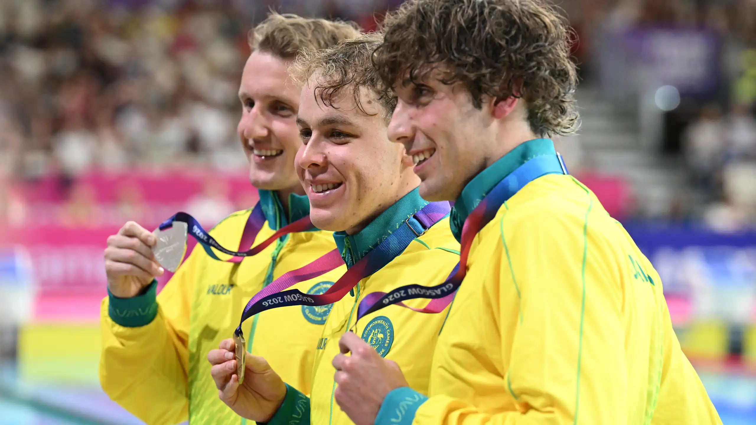 Australians Elijah Winnington, Sam Short, and Benjamin Goedemans celebrate their medals from the 400m freestyle final at the Glasgow Commonwealth Games.