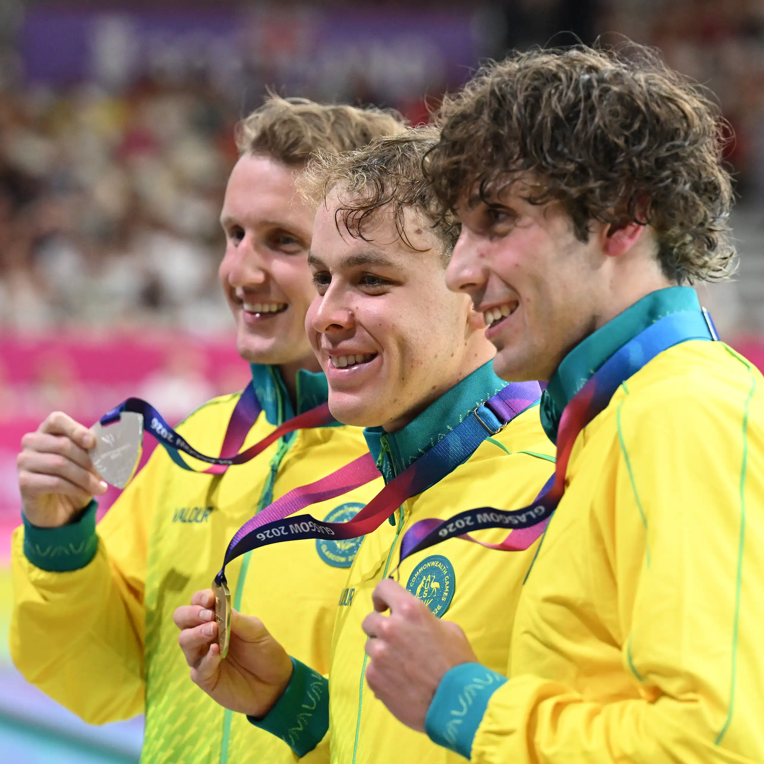 Australians Elijah Winnington, Sam Short, and Benjamin Goedemans celebrate their medals from the 400m freestyle final at the Glasgow Commonwealth Games.