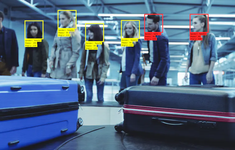 Queue in airport being scanned.