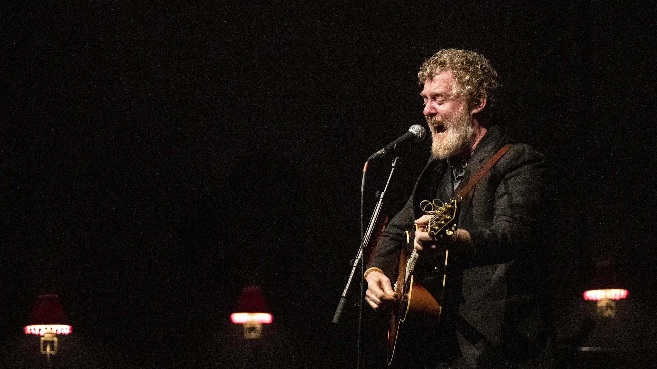 Glen Hansard performs on stage.