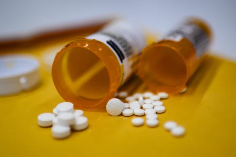 pills spilling from two orange bottles