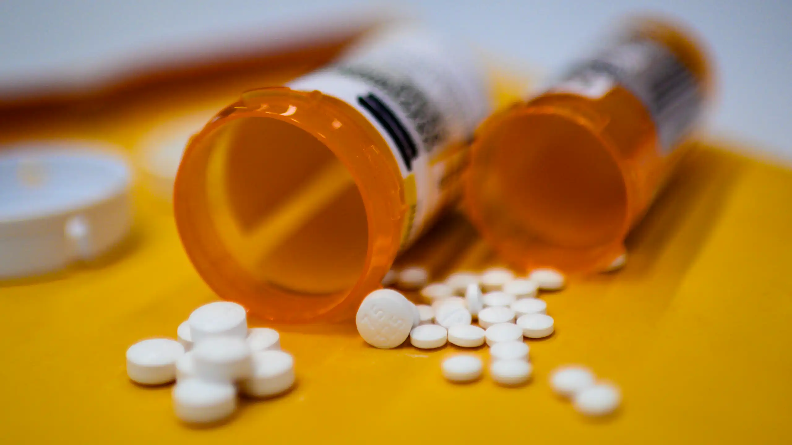 pills spilling from two orange bottles