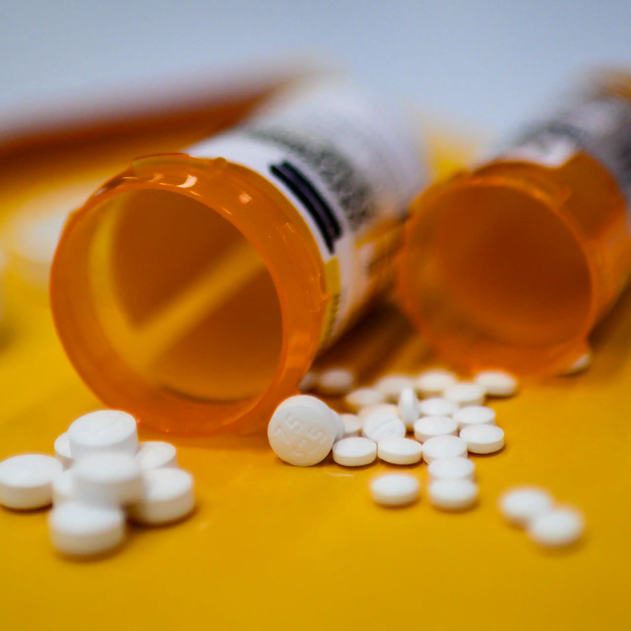 pills spilling from two orange bottles