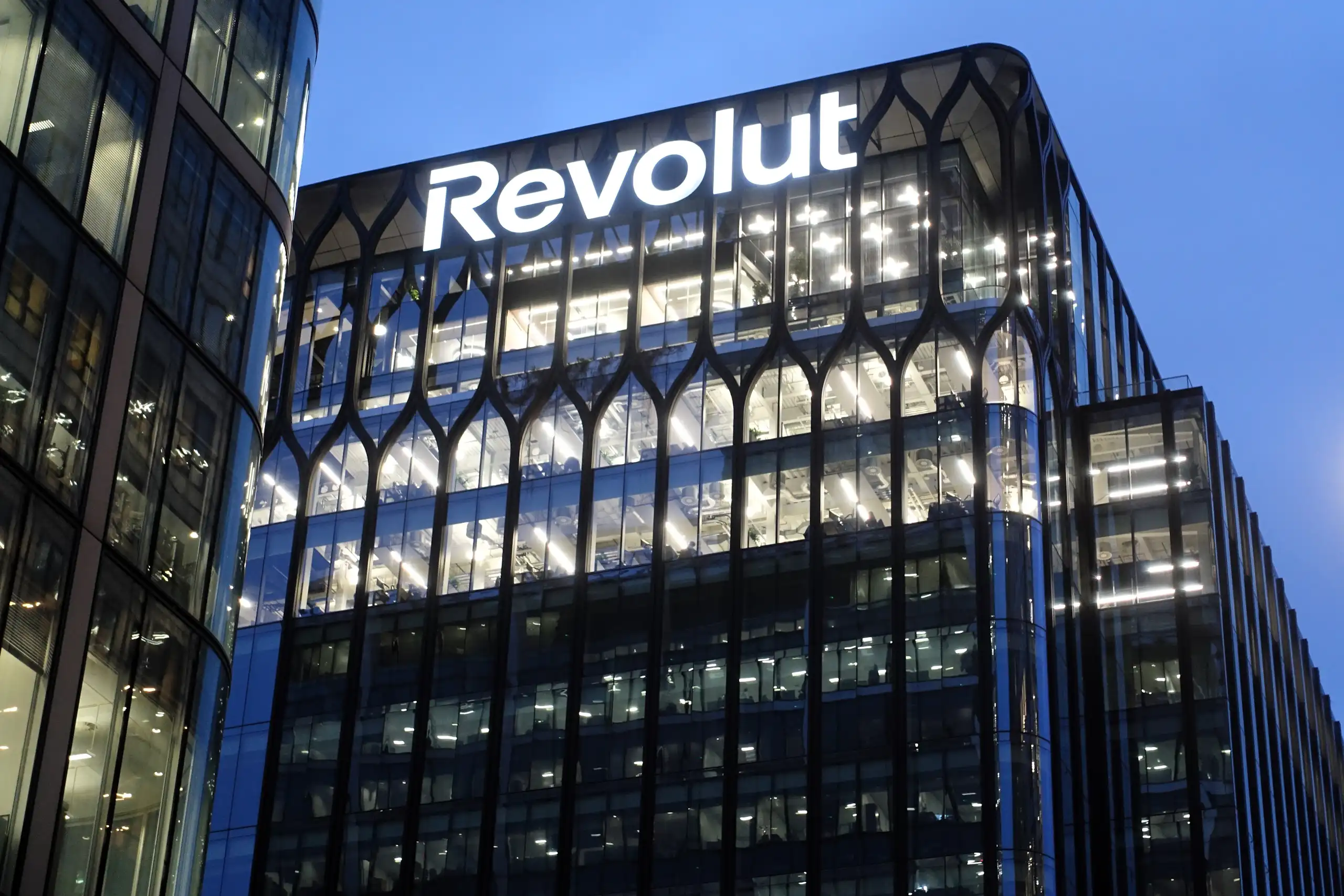 Signage on the exterior of the Revolut global headquarters building in Canary Wharf, London