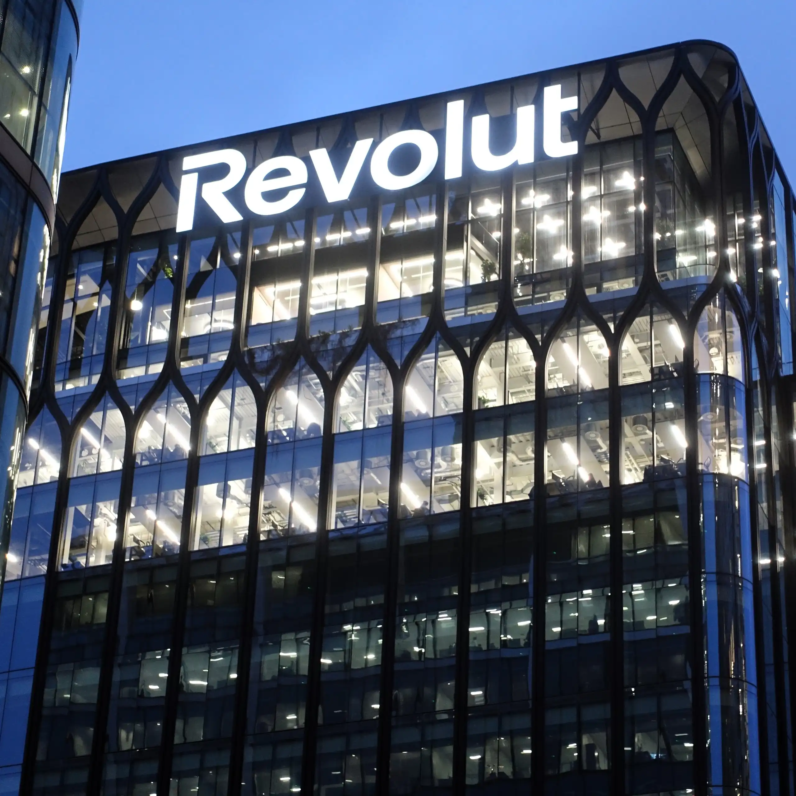Signage on the exterior of the Revolut global headquarters building in Canary Wharf, London