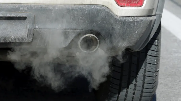 A cloud of exhaust emerges from a vehicle tailpipe.