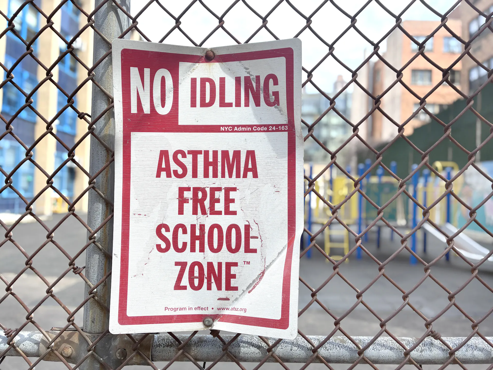 A sign reads 'No idling. Asthma free school zone.'