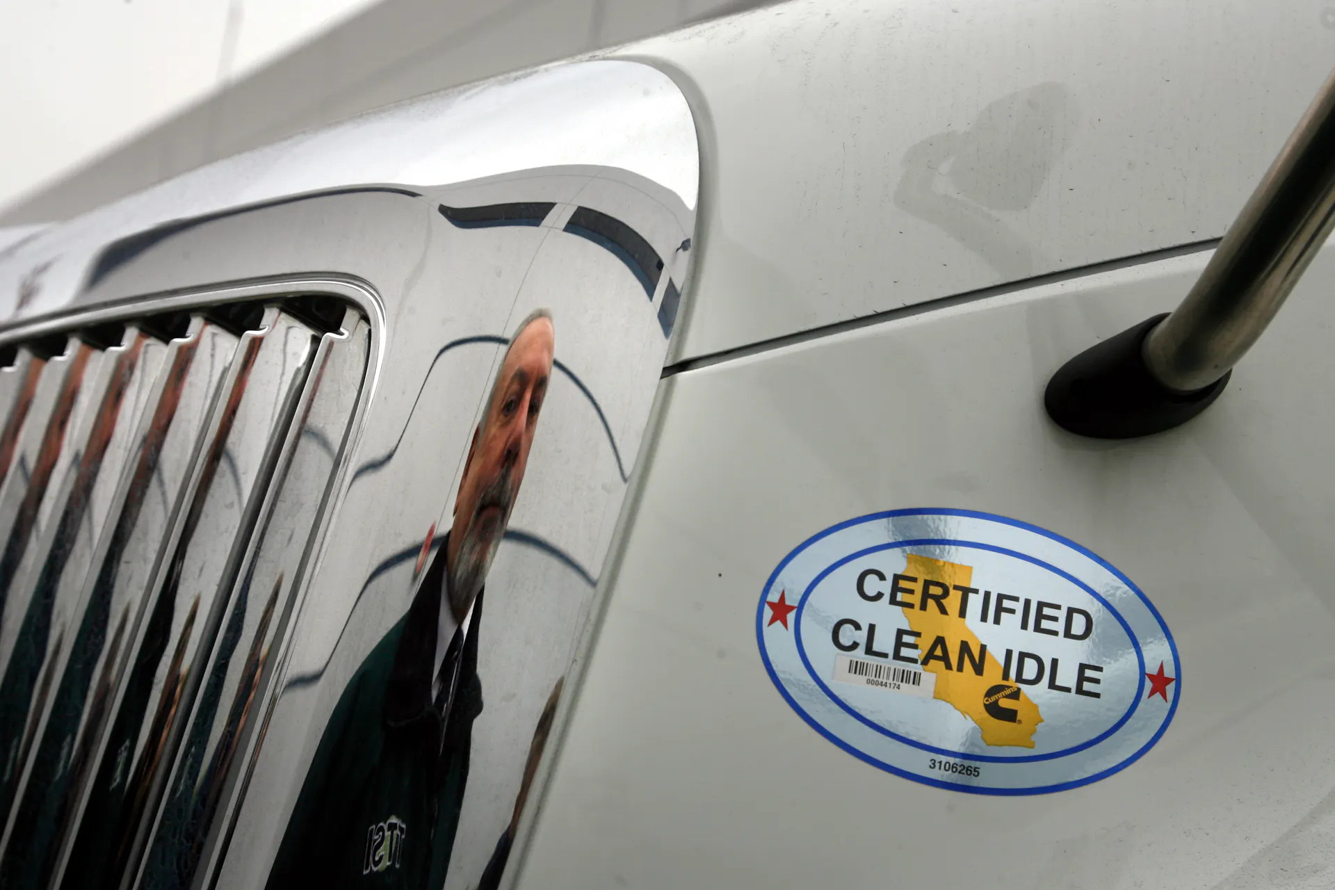 A truck has a sticker on it reading 'certified clean idle.'
