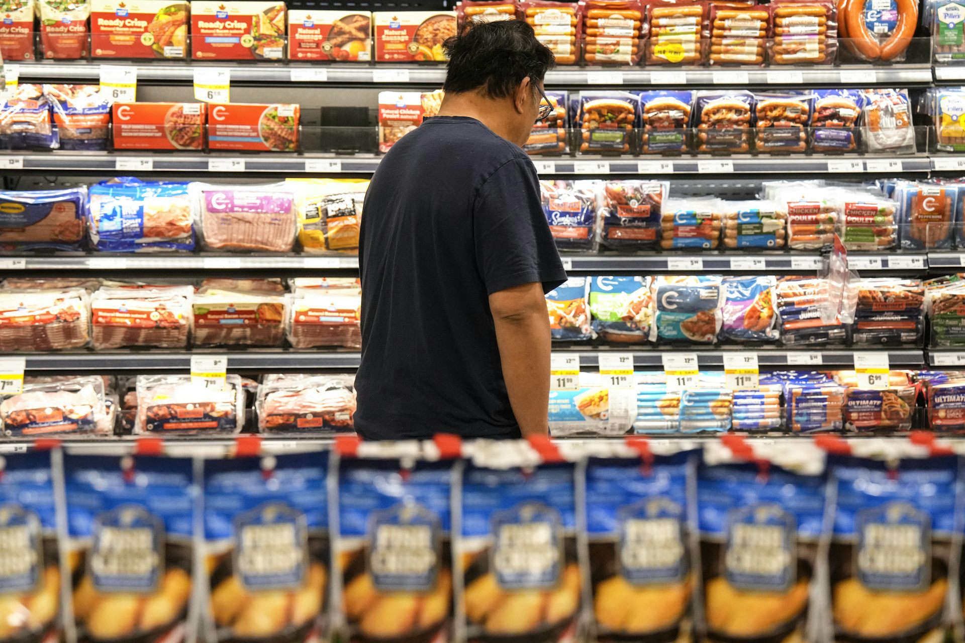 A customer shops for processed meat products