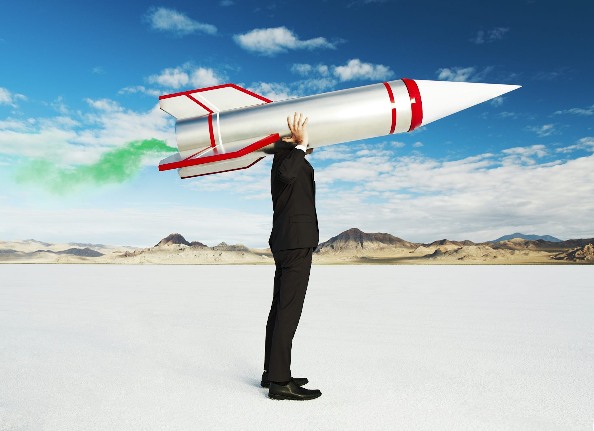 a businessman with a rocket on his head