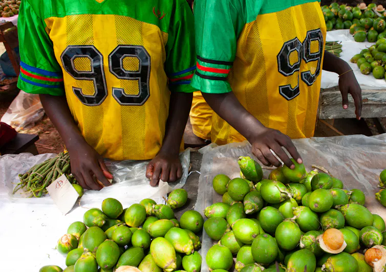 Women in sports shirts selling betel nuts