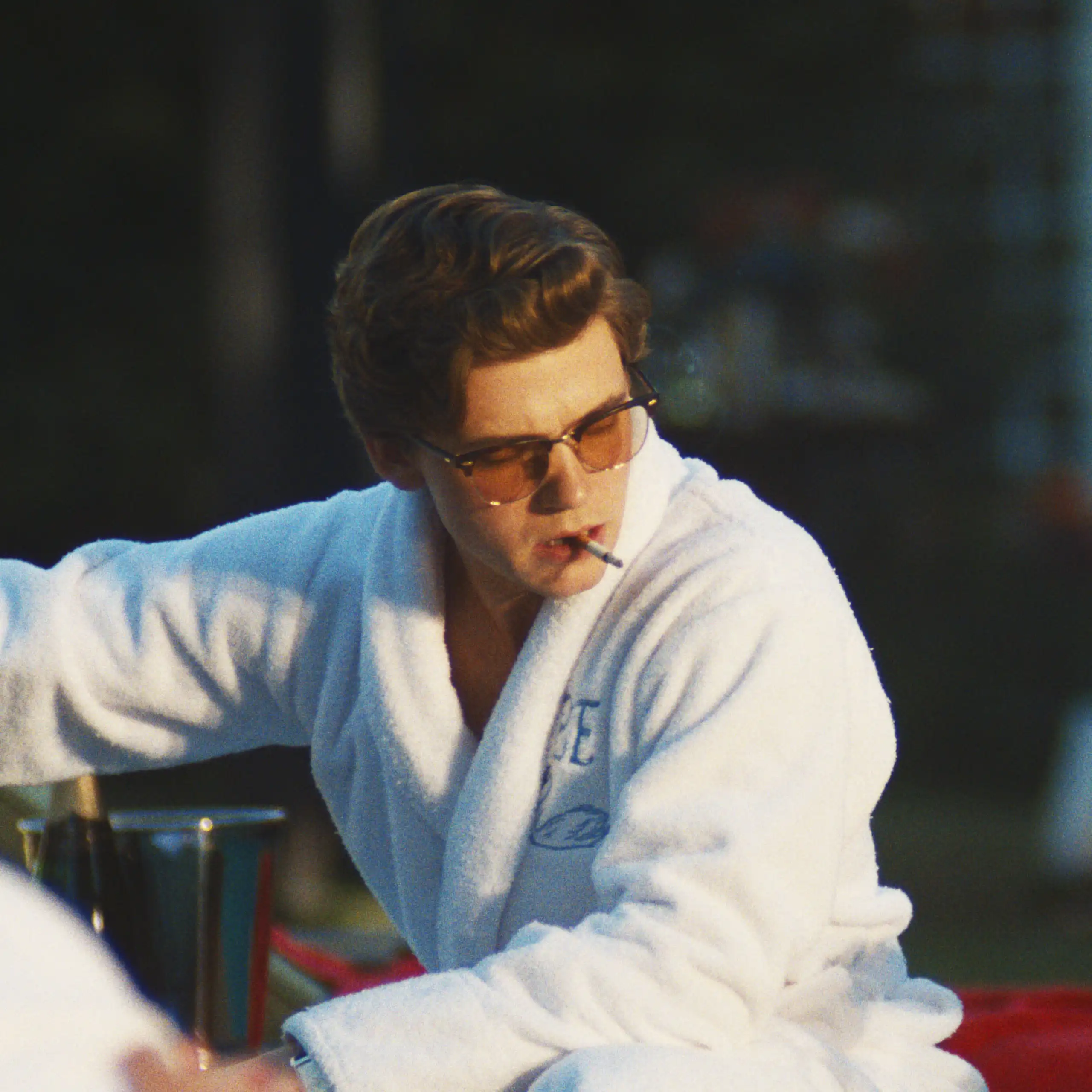 Production still: two rich teenagers in bathrobes.
