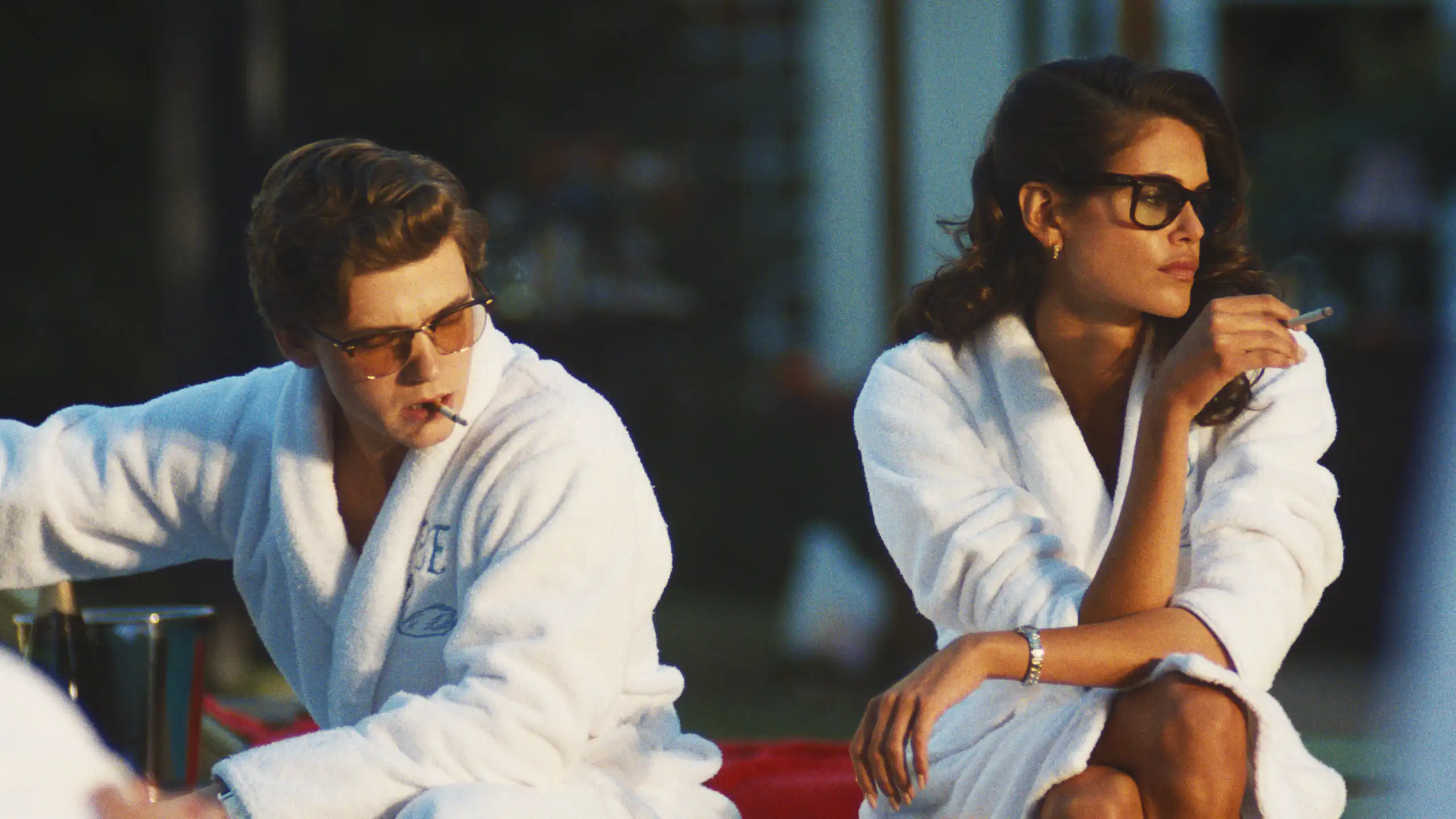 Production still: two rich teenagers in bathrobes.