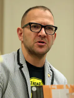 man in glasses and striped blazer