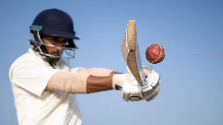 Close up of a cricket batsman hitting a ball
