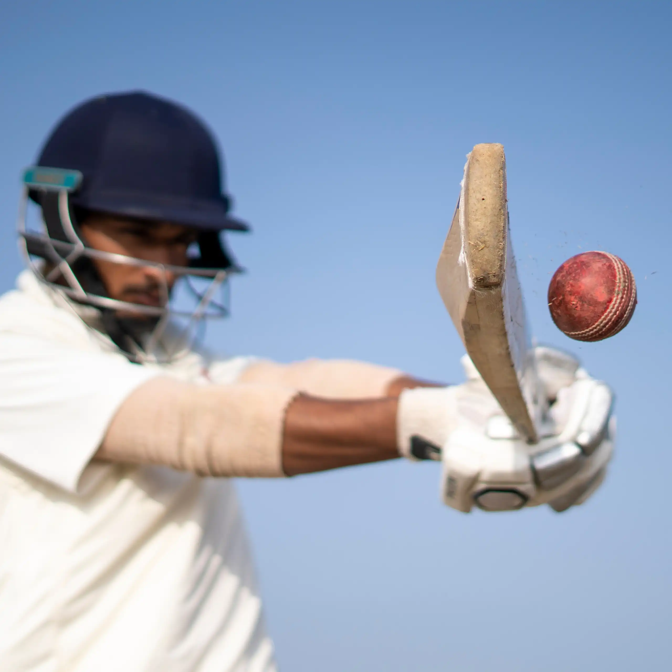 Close up of a cricket batsman hitting a ball