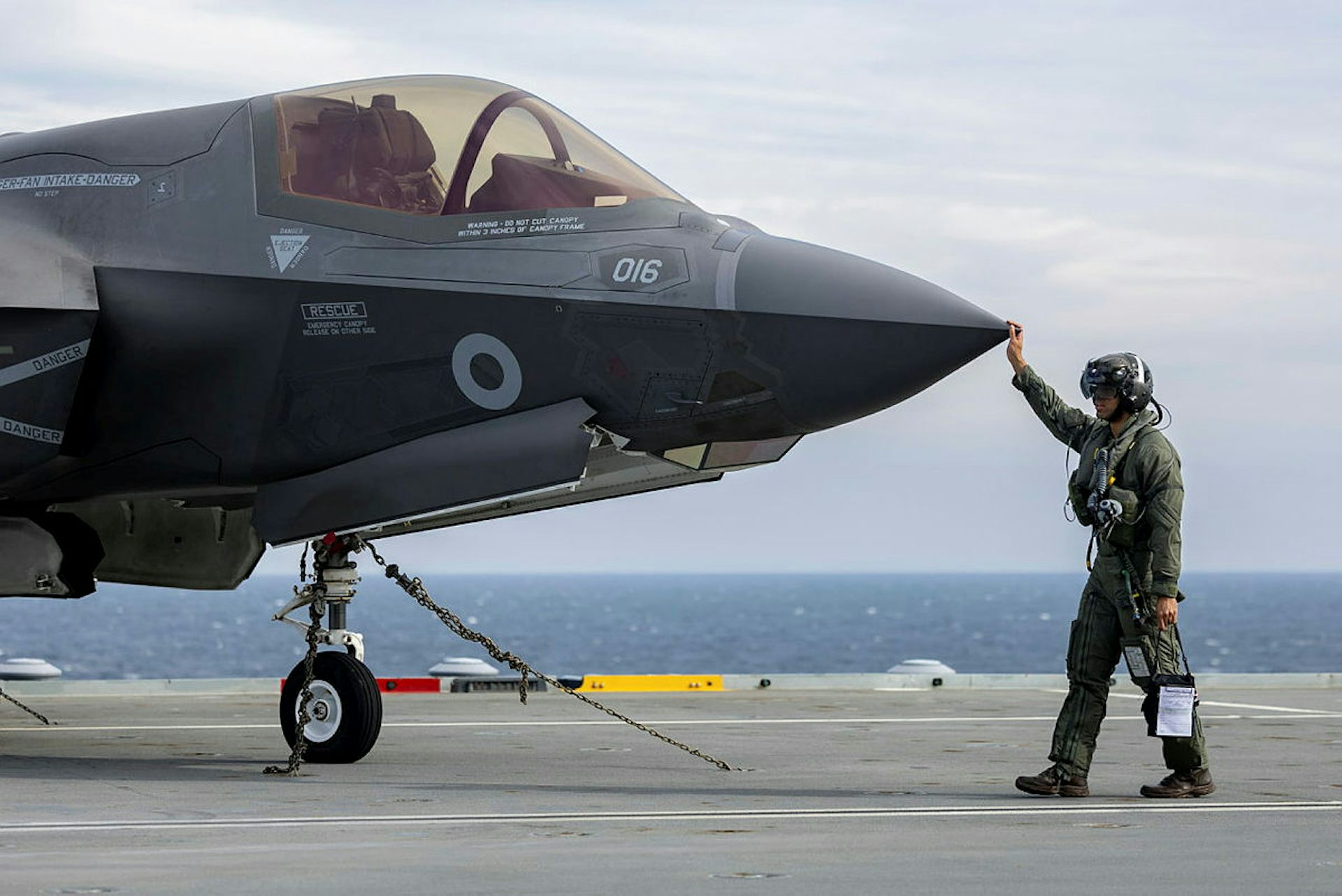 F-35 Pilot conducts walk around checks before starting up jet.