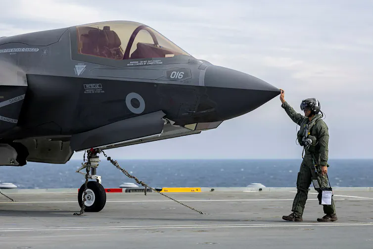 F-35 Pilot conducts walk around checks before starting up jet.