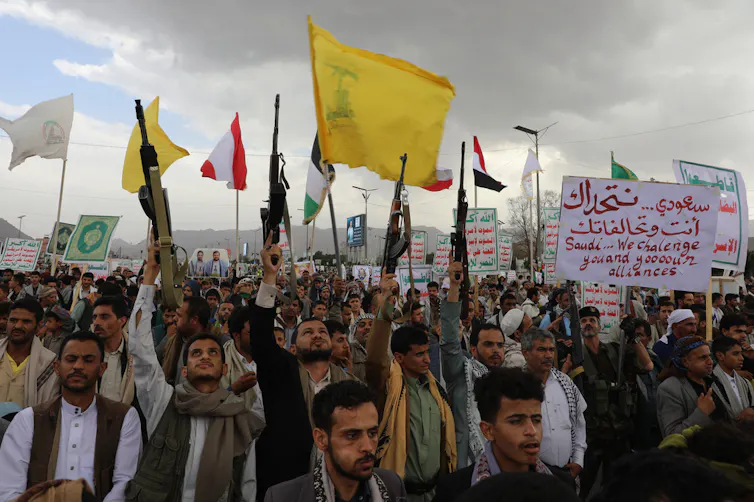 Men chant at a rally.