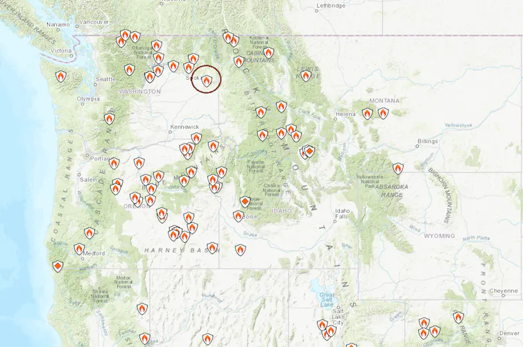 A map of the western U.S. shows several active fires. Spokane, in eastern Washington, is circled.