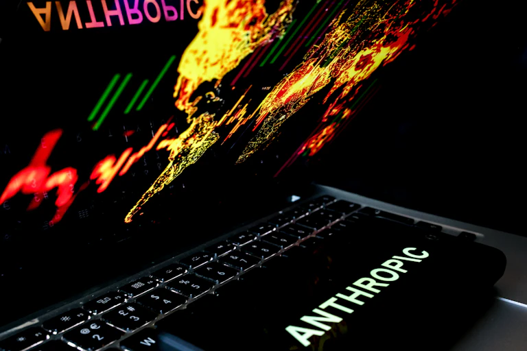 Image of a laptop showing a map of the world and the Anthropic logo
