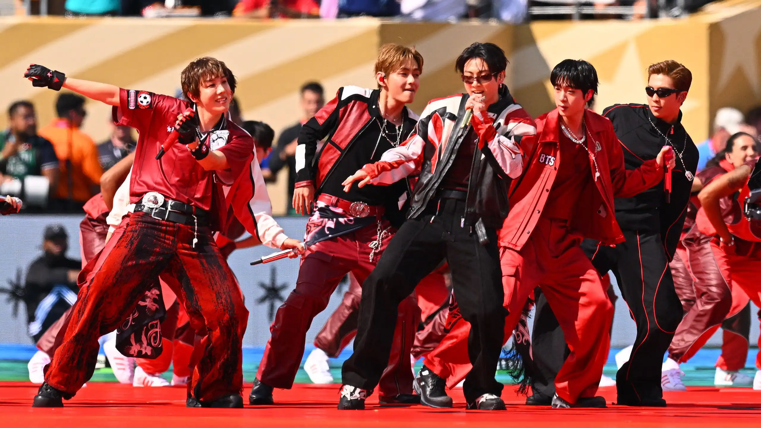 Members of BTS singing and dancing
