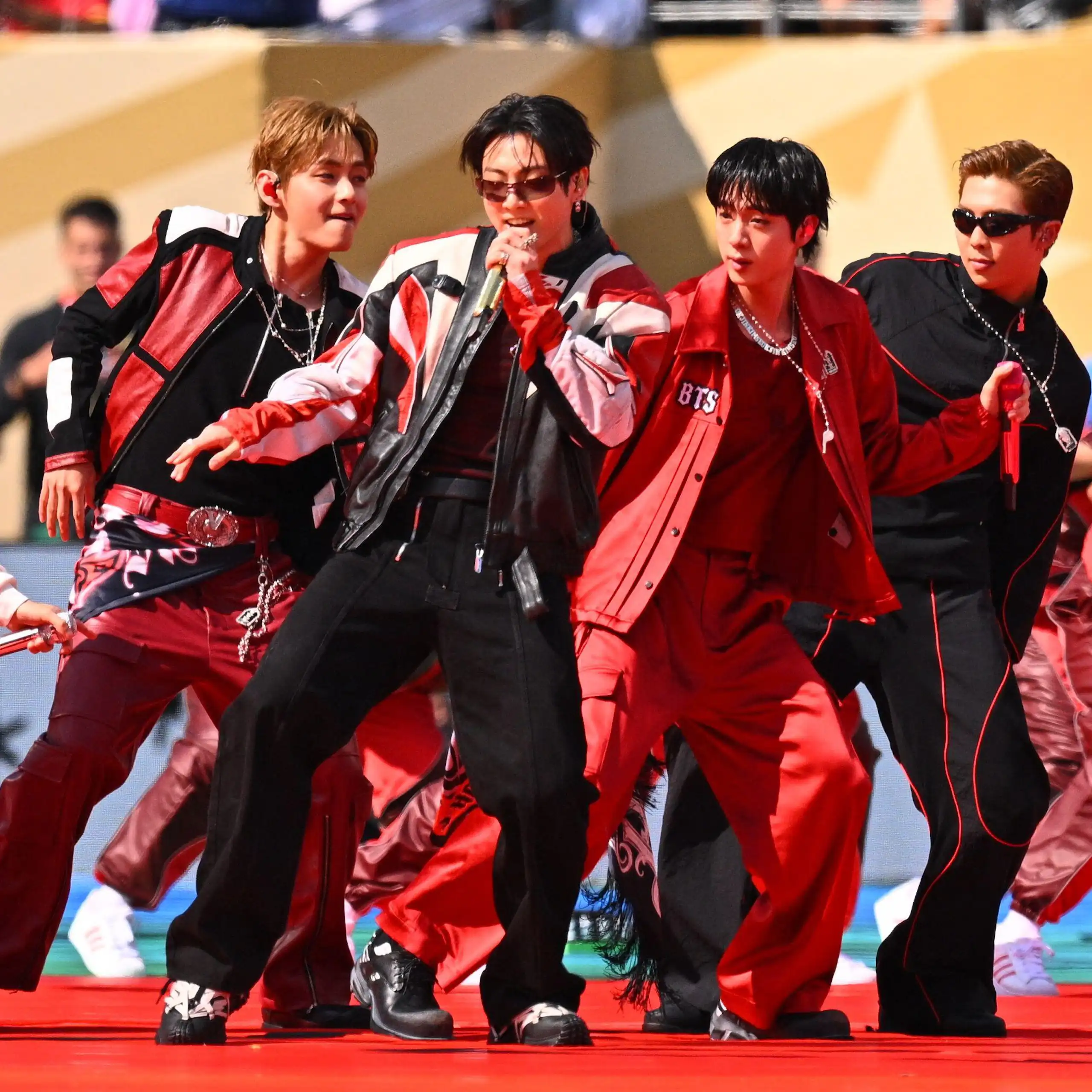 Members of BTS singing and dancing