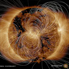 An image of a giant sphere with curving and messy white lines going around it in various directions.
