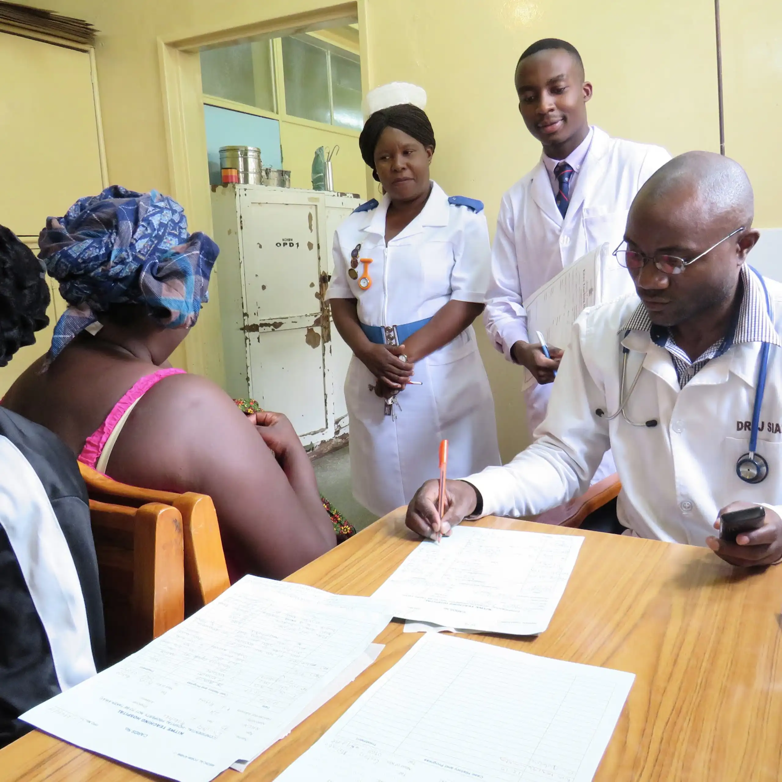 Medical staff consulting with a client