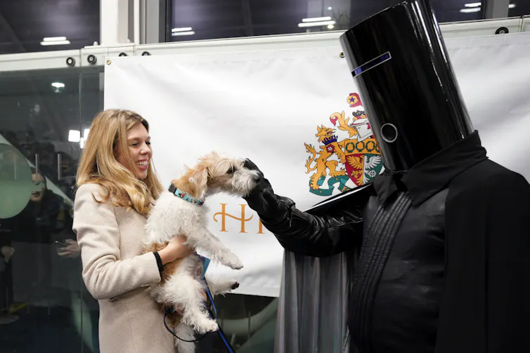 Lord Buckethead petting Carrie Symonds' dog