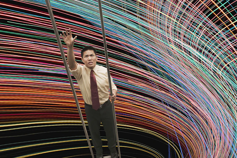 A businessman is unable to reach next rung on a a ladder against a swirling backdrop.