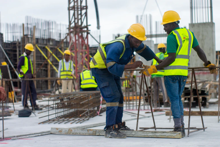 Men in reflective vests and hard hats on a construction site