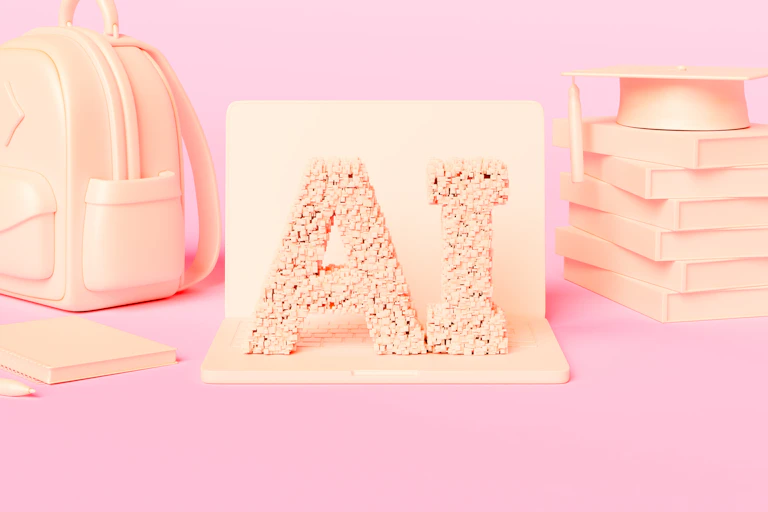 Peach-colored letters spelling AI rest next to a backpack and a pile of books with a graduation hat on top, against a light pink background.