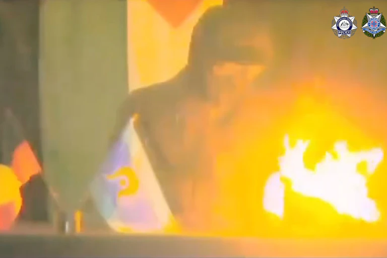 A grainy image shows an alleged arsonist in an attack on a Melbourne defence manufacturer.