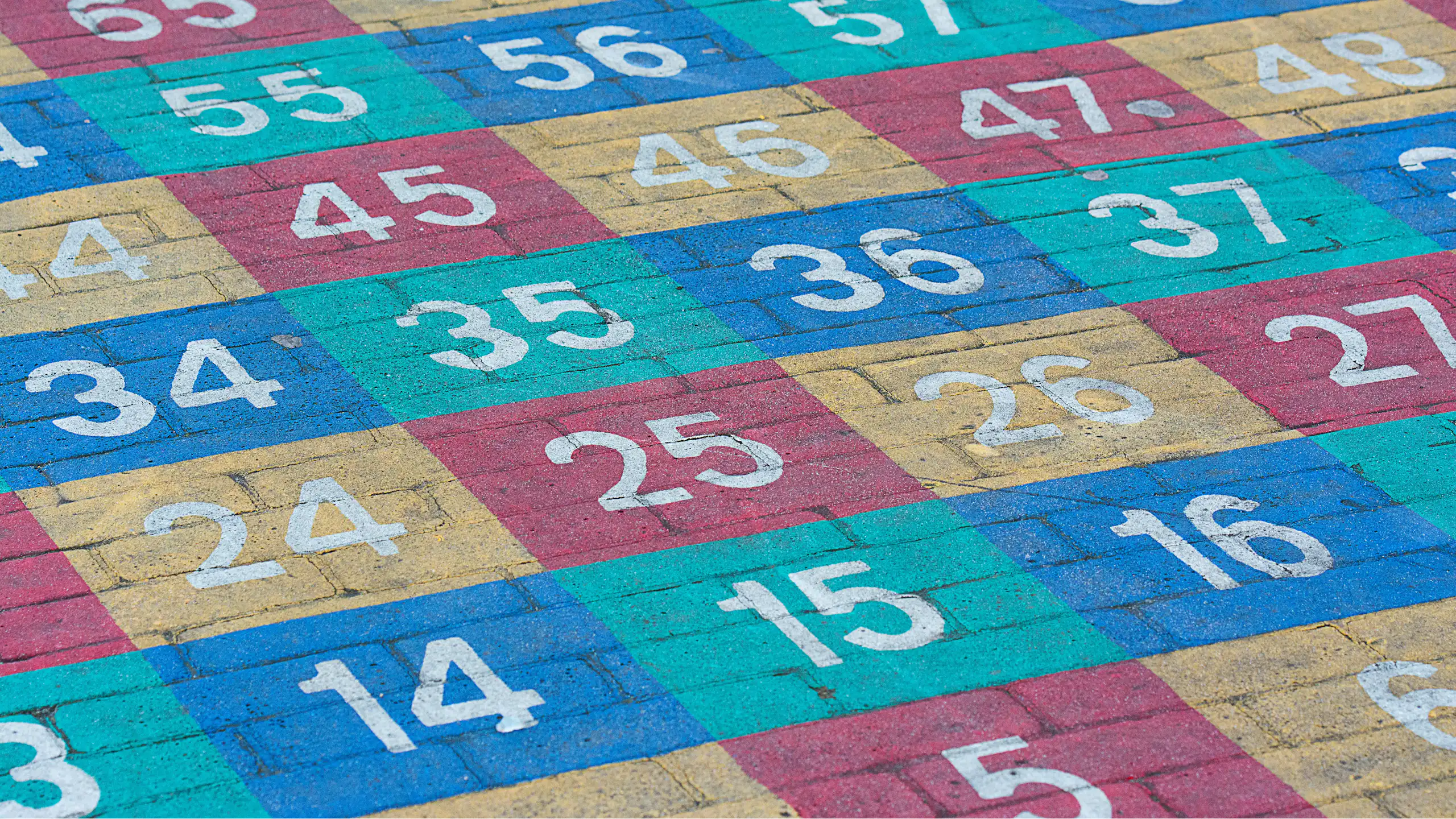 Coloured numbers painted on concrete.
