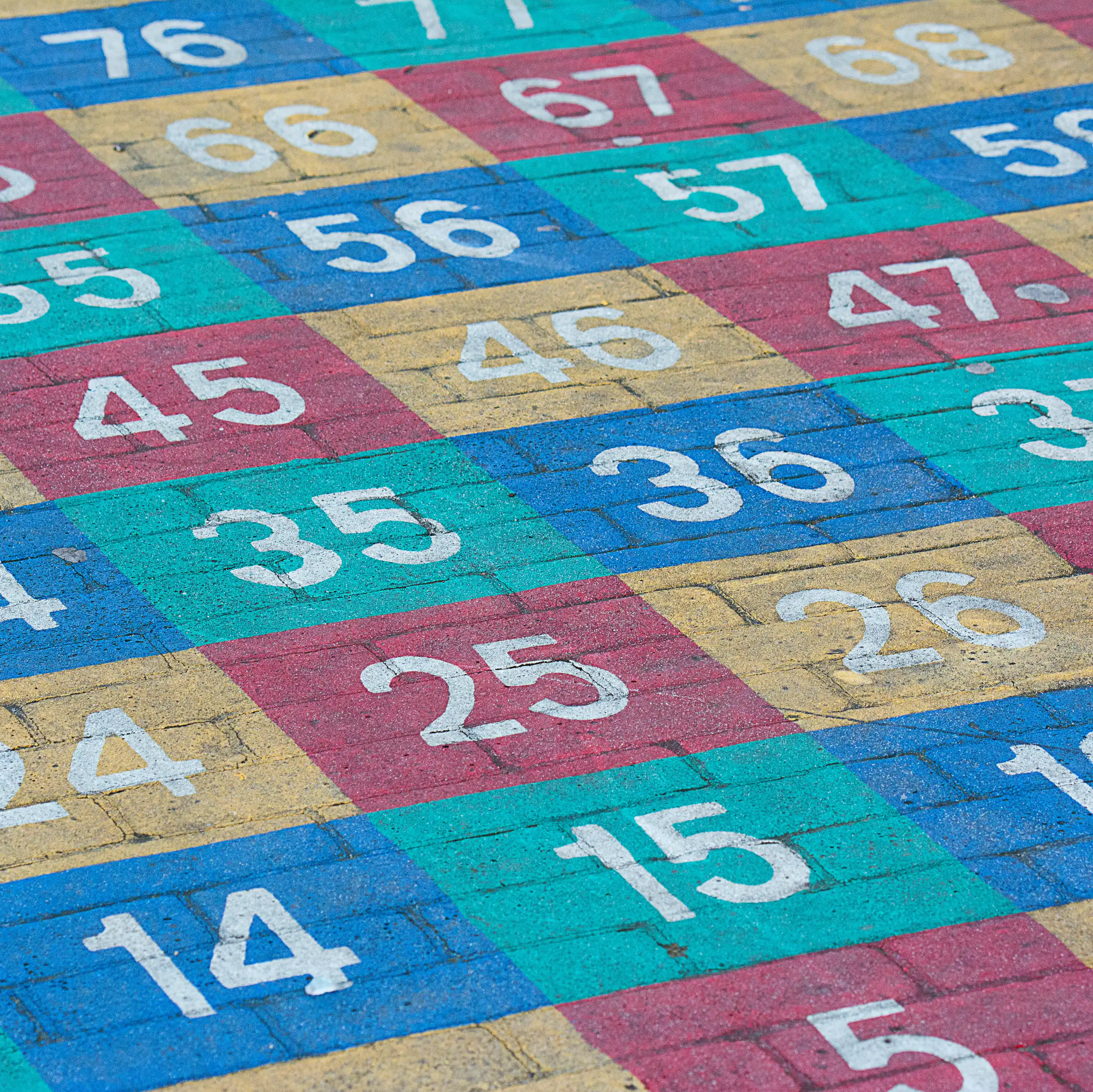 Coloured numbers painted on concrete.
