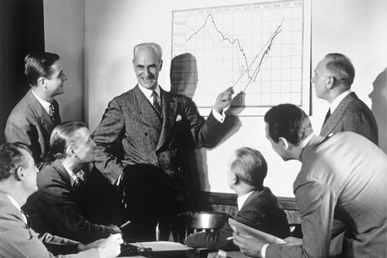 A group of businessmen laughing while looking at a chart