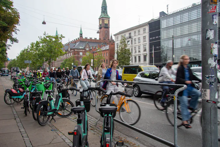 Cyclists and cars in the streets of Copenhagen, Denmark.